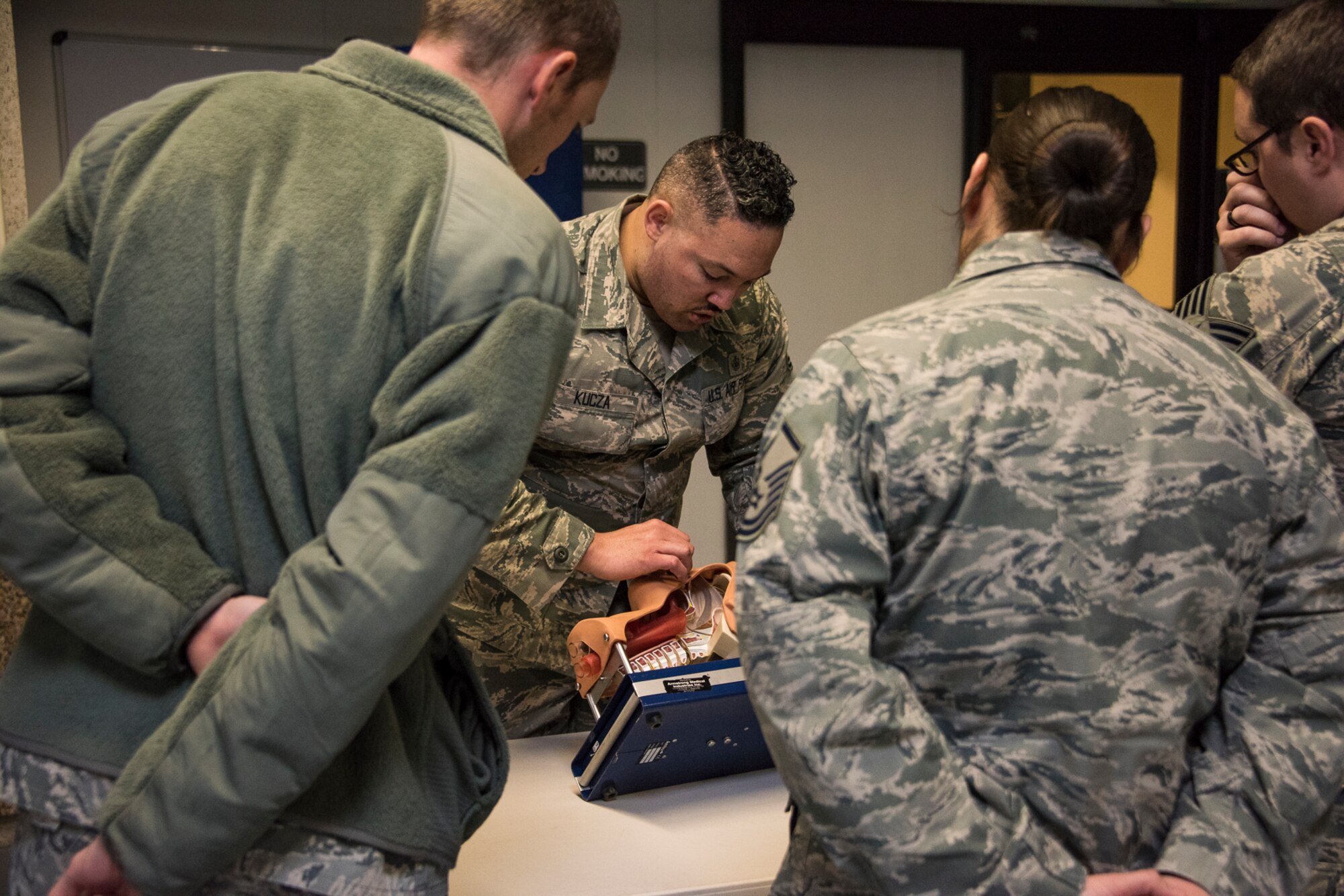 Reservists in the 419th Fighter Wing practice how to keep an airway clear during a Self-Aid and Buddy Care refresher class