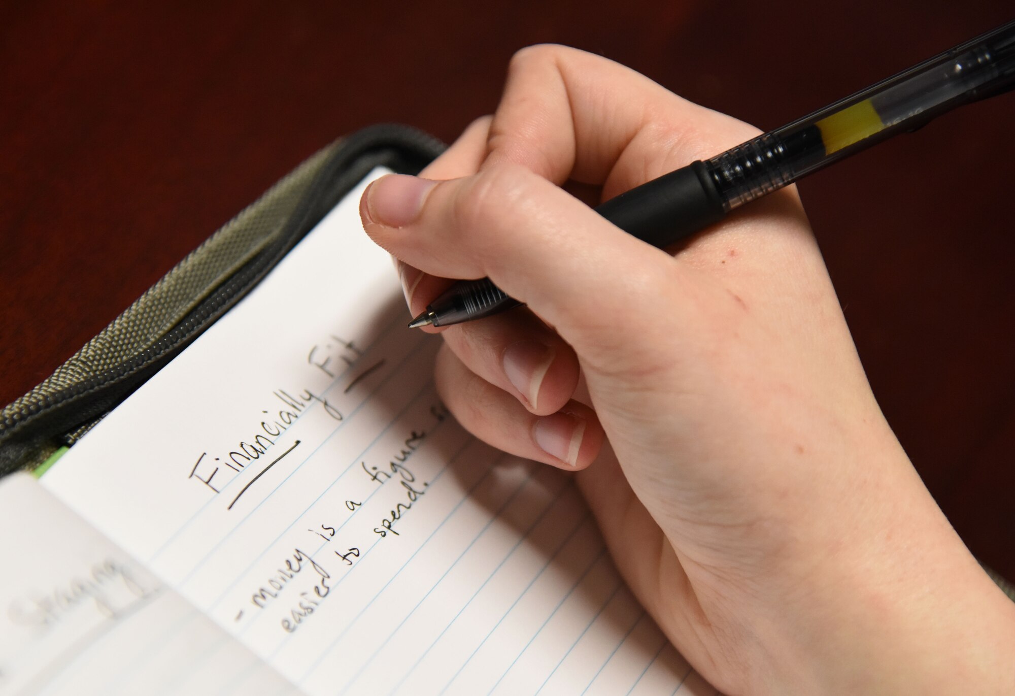 Airman 1st Class Leah Hammack, 81st Force Support Squadron force management technician, takes notes during a “Are you Financially Fit?” session at the Sablich Center Feb. 28, 2018, on Keesler Air Force Base, Mississippi. The session was one of three held during military saves week. (U.S. Air Force photo by Kemberly Groue)