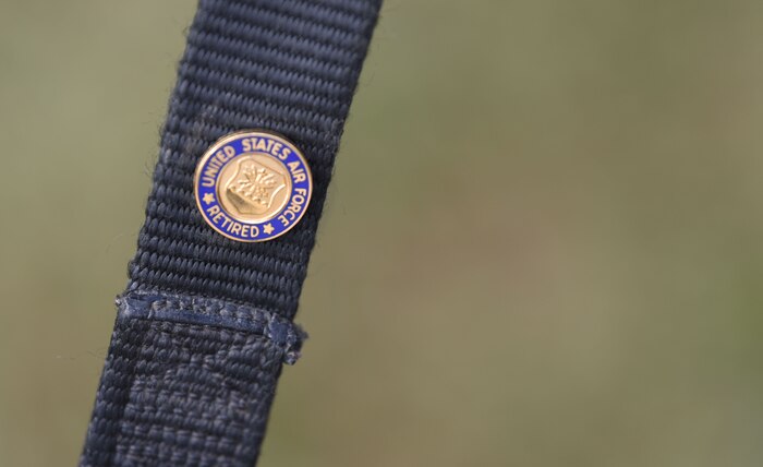 A retirement pin rests on the collar of a Military Working Dog at the MWD Retirement Ceremony Feb. 23, 2018, at the Air Base theater. Retirement ceremonies honor the service given to the military from its members, including MWDs. This retirement ceremony honored three of Joint Base Charleston’s MWDs -- Shark, Chico and Jaga – for their valued service.
