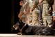 Military Working Dog Shark, 628th Security Forces Squadron, rests on stage of the MWD retirement ceremony Feb. 23, 2018, at the base theater. The retirement ceremony includes presentation of the meritorious service medal, retirement pin and a bone presentation.
