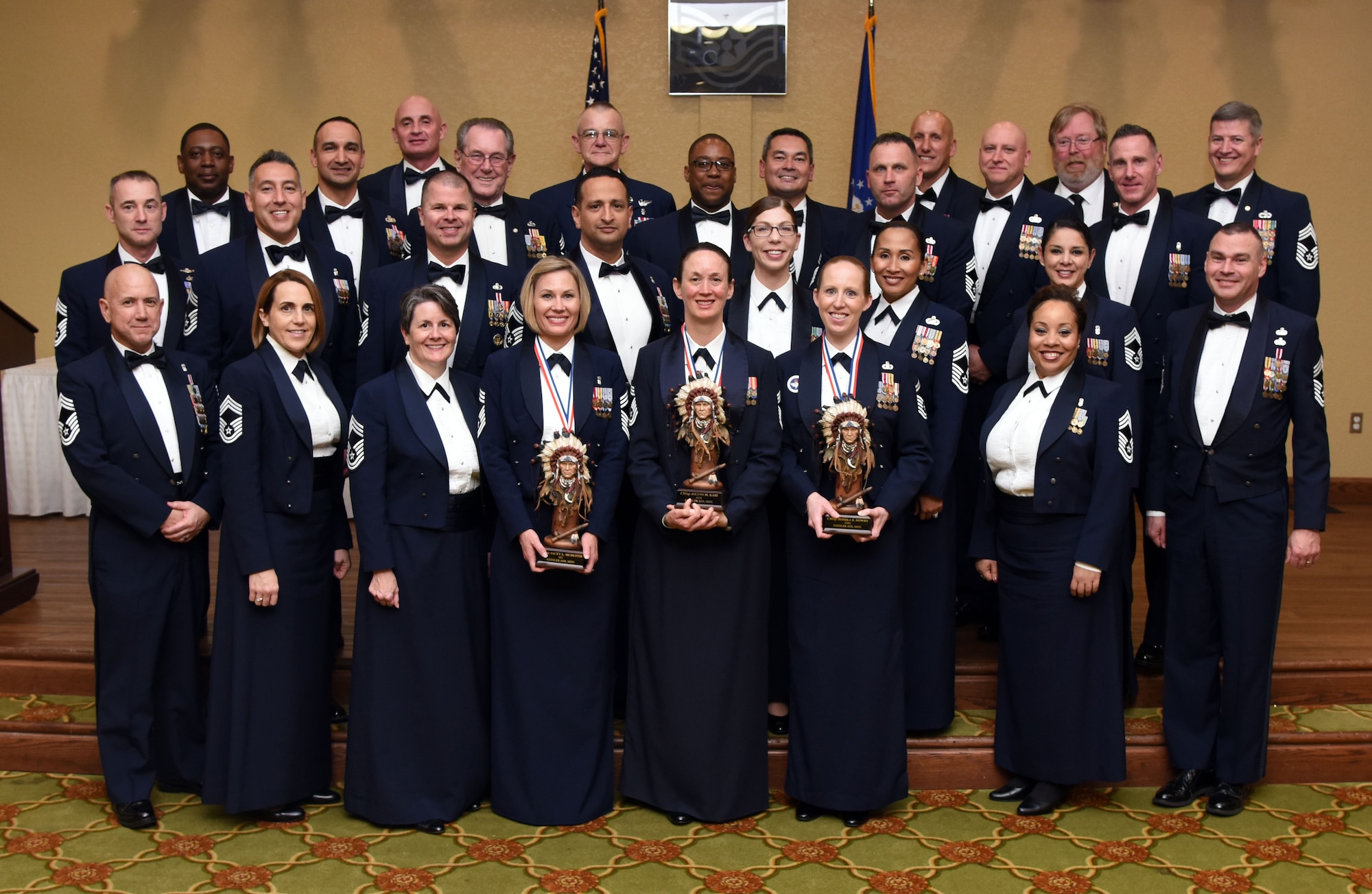 Keesler’s chief master sergeants pose for a photo with Keesler’s newest Chief Master Sergeants during a candle lighting ceremony during the Chief Induction Ceremony at the Bay Breeze Event Center March 1, 2018, on Keesler Air Force Base, Mississippi. Three Keesler Airmen earned their chief master sergeant stripe during the 2018 promotion release. (U.S. Air Force photo by Kemberly Groue)