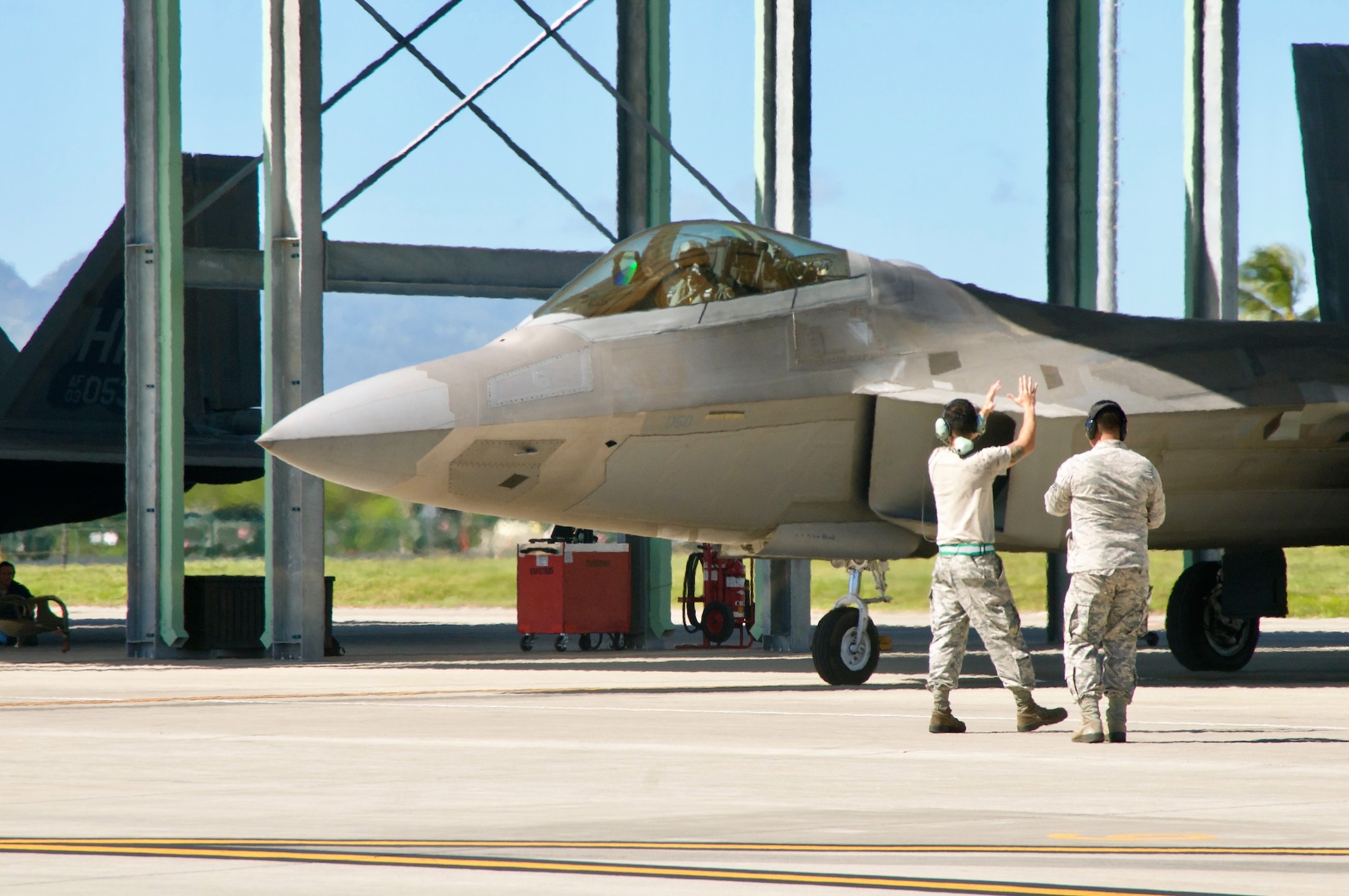 Two crew chiefs with the 154th Maintenance Group, Hawaii Air National Guard prepare to launch a F-22 Raptor at Joint Base Pearl Harbor-Hickam on Jan. 16, 2018 as part of Sentry Aloha exercises.