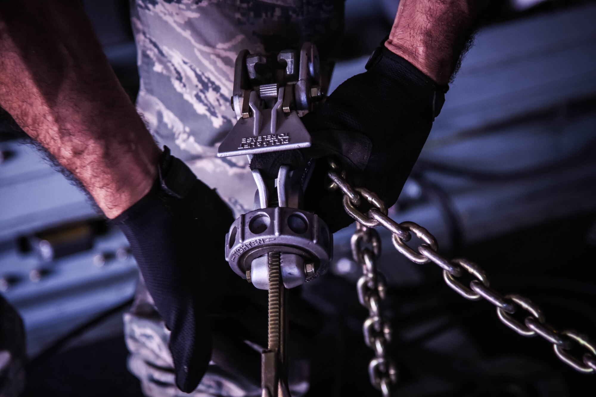 Senior Airman Daniel Rodriguez, 41st Aerial Port Squadron air transportation specialist, locks down cargo during a training event on the flight line at Keesler Air Force Base, Mississippi, March 4, 2018. This training was a culmination of every process for which the aerial port is responsible. (U.S. Air Force photo by Senior Airman Nathan Byrnes)