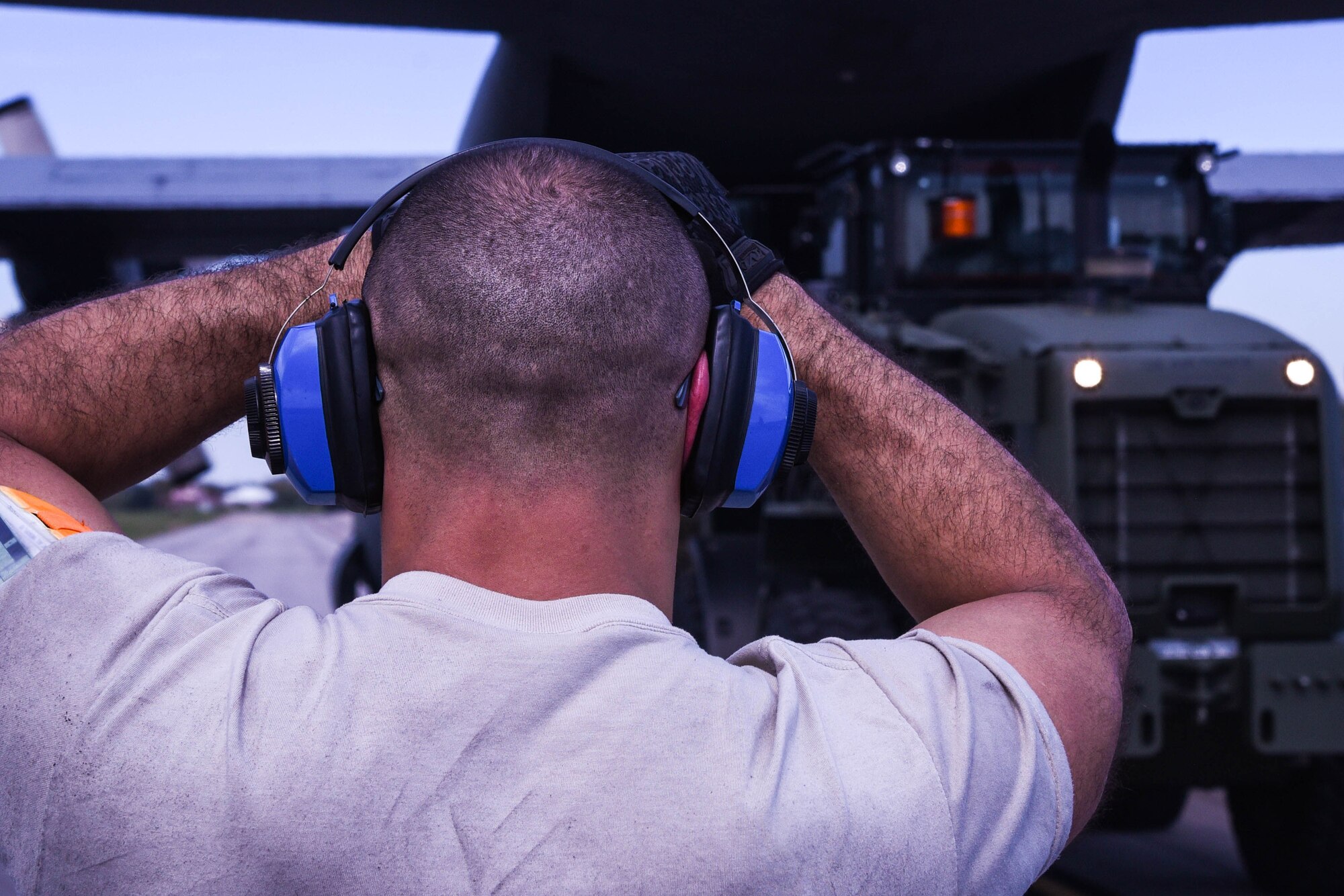 Senior Airman Daniel Rodriguez, 41st Aerial Port Squadron air transportation specialist, guides a Reserve Citizen Airman backing up a vehicle after loading cargo onto a C-130H Hercules aircraft at Keesler Air Force Base, Mississippi, March 4, 2018. The aerial port squadron is made up of several work centers, including passenger service, fleet service, ramp, (the air terminal operations center), load planning, data records, cape forecasting, aerial delivery and cargo processing, and is responsible for getting all the air cargo and passengers on and off the aircraft. (U.S. Air Force photo by Senior Airman Nathan Byrnes)