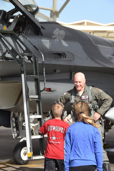 Lt. Col. Ryan Savageau, 944th Operations Group deputy commander, is greeted by his daughter, Colbie, and son, Luke, after his 3,000th hour piloting an F-16, Feb. 27.