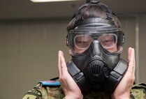 Japan Ground Self-Defense Force Sergeant Seijiro Kaharu, a 1st Training Unit battle management system operator from Camp Higashi-Chitose, Hokkaido, Japan, tests a gas mask seal during a JGSDF shadow program at Misawa Air Base, Japan, March 5, 2018. Approximately 20 members from Camp Higashi-Chitose transition through three levels, basic, intermediate and advanced, of the JGSDF English program. As a part of their basic English course curriculum, Misawa provides an opportunity for the JGSDF members to apply their acquired language skills by grouping JGSDF members together with their U.S. Air Force counterparts who perform similar jobs. (U.S. Air Force photo by Senior Airman Sadie Colbert)
