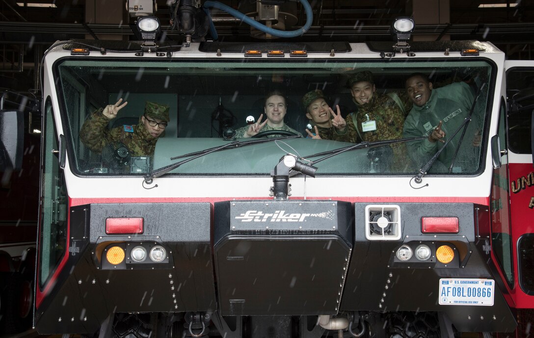 Japan Ground Self-Defense Force Soliders from 1st Training Unit, Camp Higashi-Chitose, Hokkaido, Japan, and U.S. Air Force Airmen with the 35th Civil Engineer Squadron fire department, pause for a photo during a JGSDF shadow program at Misawa Air Base, Japan, March 5, 2018. During their full day of relationship building, Airmen showed their JGSDF counterparts their unique jobs and shared how to accomplish their duties, allowing JGSDF Soldiers the opportunity to use a variety of new English words to increase their communication skills. By bridging the gap between the two languages, Team Misawa can better integrate with all branches of the Japan Self-Defense Force increasing mission fluidity. (U.S. Air Force photo by Senior Airman Sadie Colbert)