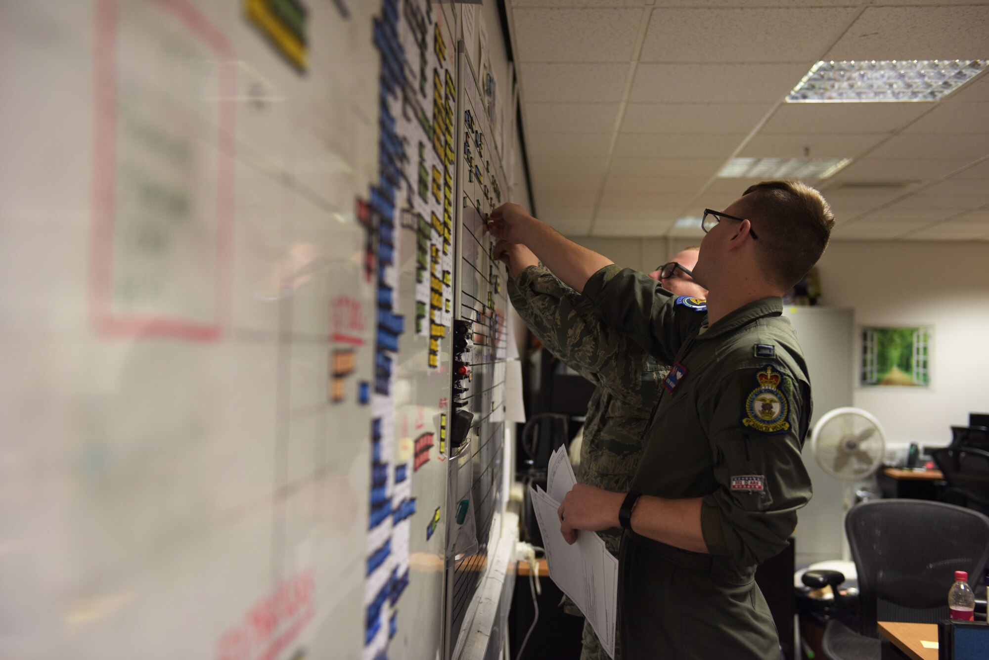 U.S. Air Force Capt. Kevin Brohaugh, 100th Operations Group assistant chief of scheduling, and Staff Sgt. Christopher Shelton, 100th Operations Group NCO-in-charge of scheduling, prepare crew schedules for a readiness exercise at RAF Mildenhall, England, Feb. 26, 2018.  The exercise tested the wing’s ability to rapidly mobilize an entire wing and prepare to launch KC-135s in response to an international incident. (U.S. Air Force photo by Airmen 1st Class Alexandria Lee)