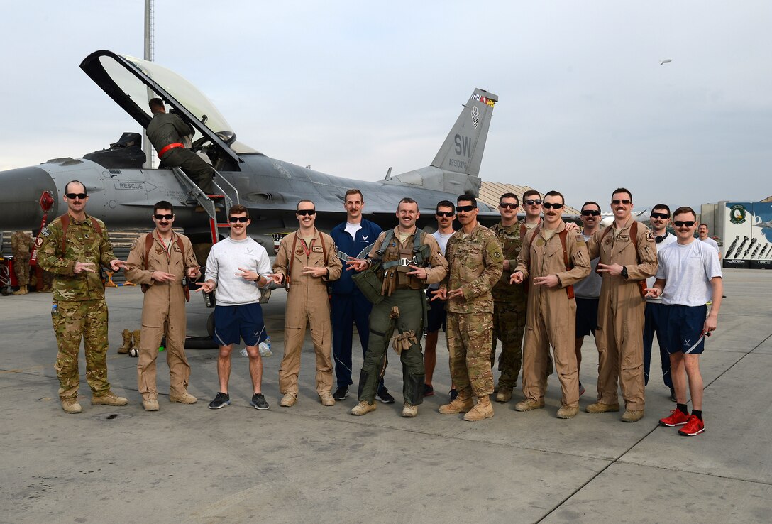 “Mach” (center), 77th Expeditionary Fighter Squadron F-16 Fighting Falcon fighter pilot, poses for a photo with members from the 77th EFS Feb. 28, 2018 at Bagram Airfield, Afghanistan.