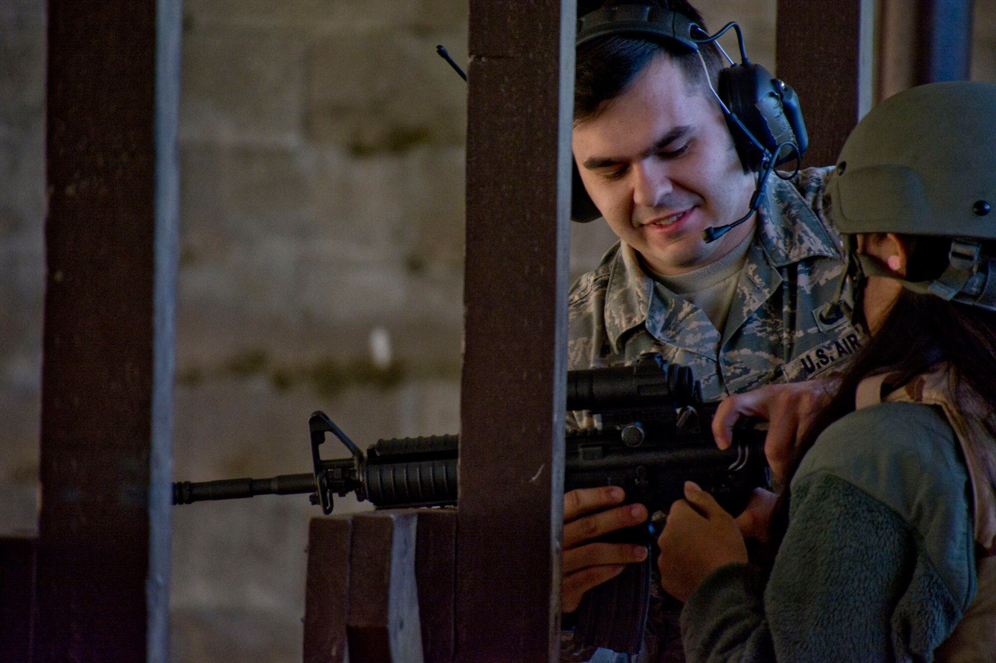 U.S. Air Force Senior Airman Taylor Bourque-Bergeron, a combat arms instructor assigned to the 19th Security Forces Squadron, assists an Airman during weapons training Feb. 10, 2018, at Little Rock Air Force Base. Ark. Combat arms instructors from the 19th SFS spent the weekend training the Reserve Airmen from the 913th Airlift Group on the M4 Carbine and M9 Pistol, which is a regular part of Air Force Reserve training requirements. (U.S. Air Force photo by Master Sgt. Jeff Walston/Released)