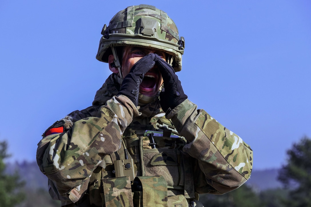 A British soldier yells out commands to U.S. soldiers.