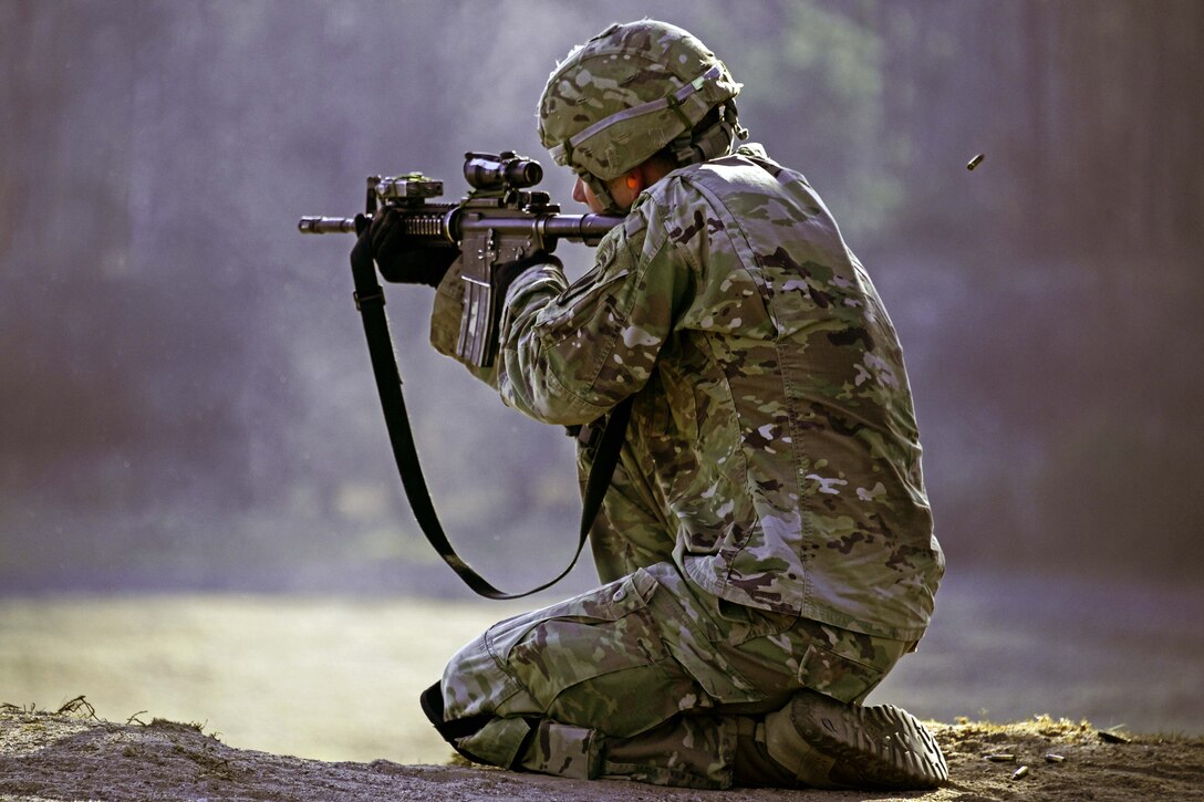 A soldier fires his weapon at targets during a live-fire range.