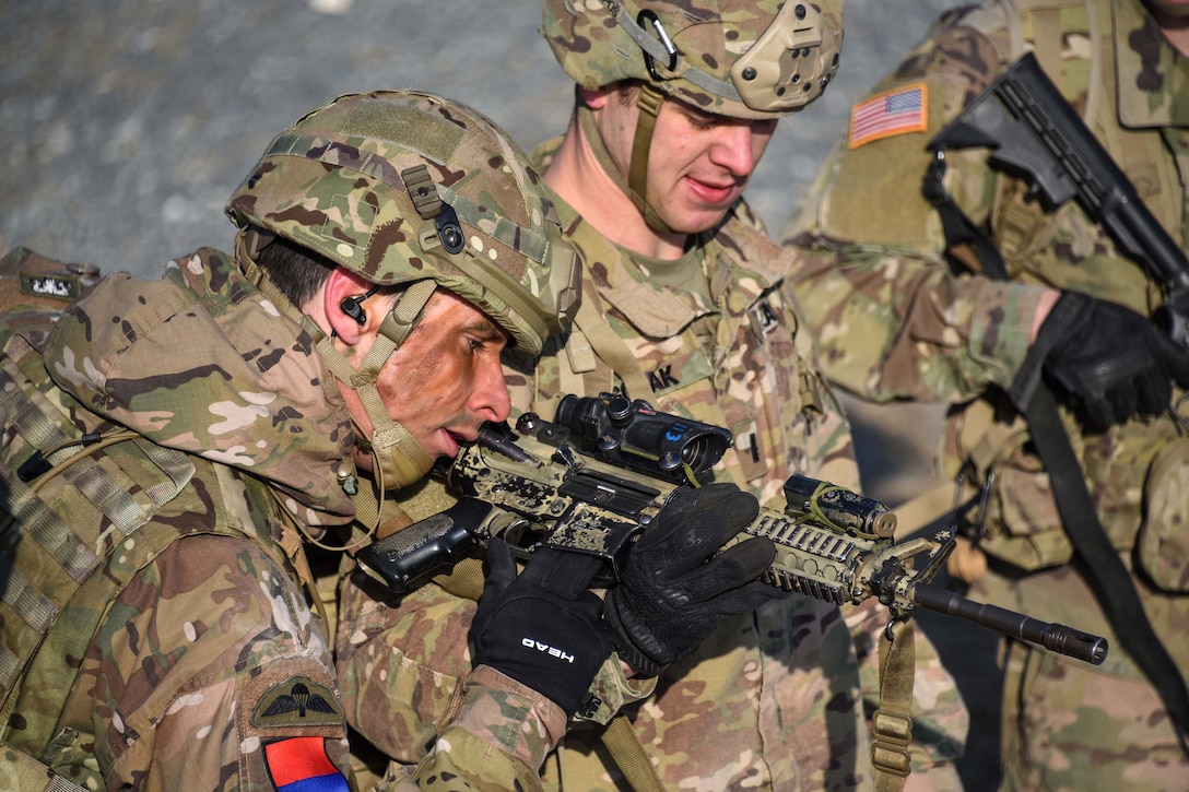 British and U.S. soldiers clear weapons.