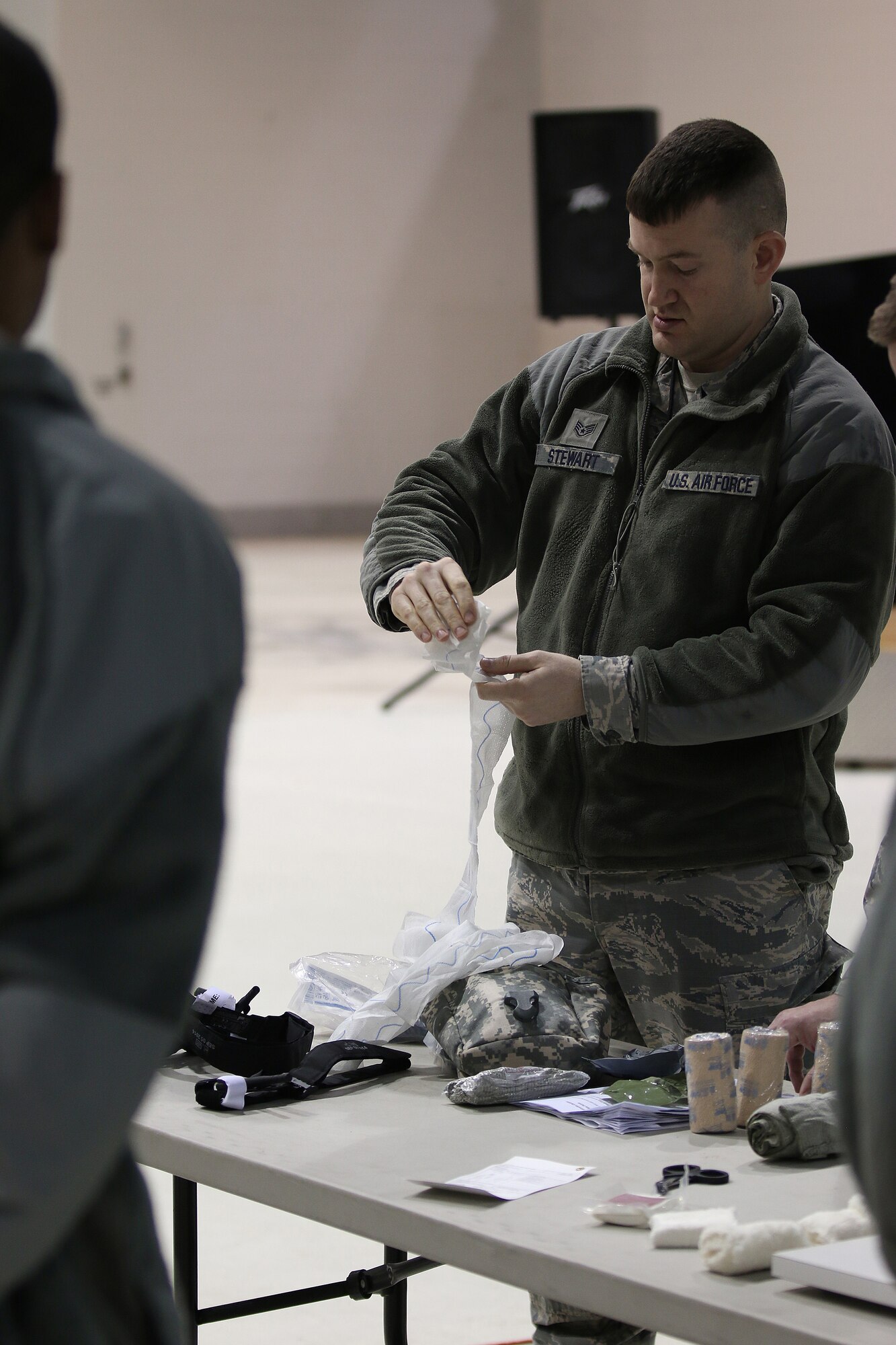 Staff Sgt. Adam Stewart, 445th Aircraft Maintenance Squadron mechanic, demonstrates how to use quick clot gauze during self-aid and buddy care training conducted during the Feb. 11, 2018 unit training assembly.