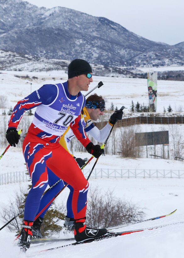 Montana and Minnesota Army National Guardsmen race up a steep hill called the “wall” during a biathlon.