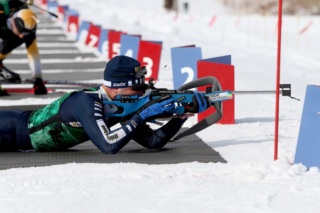 A soldier shoots at target from a prone position during a biathlon.