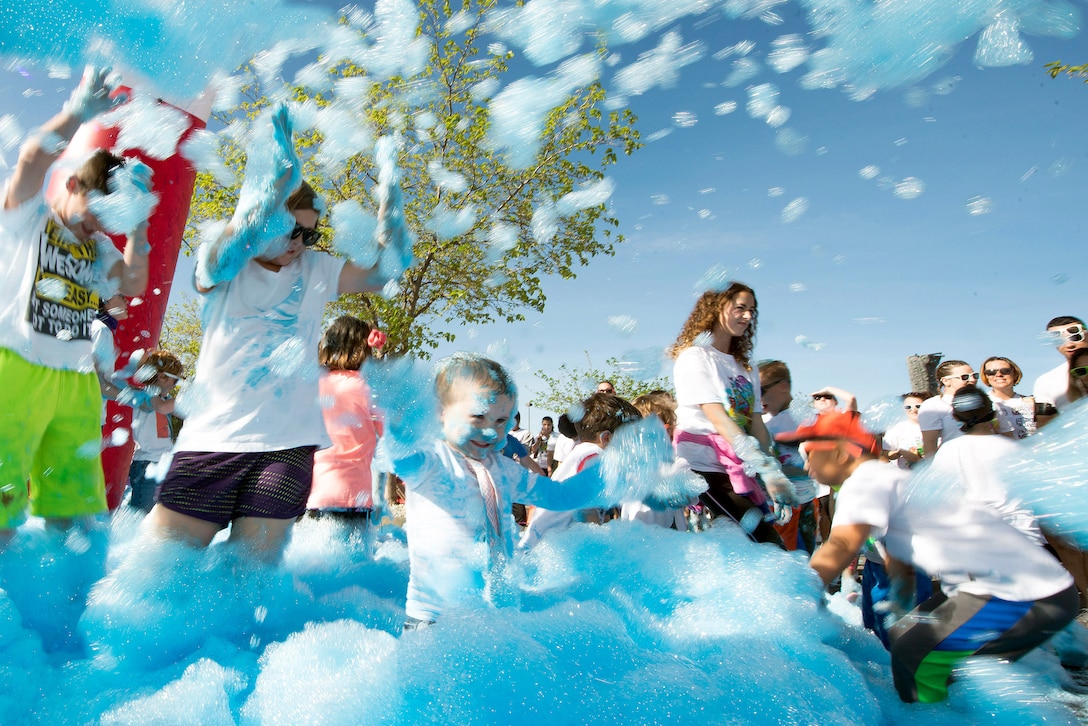 Children play in colored foam.