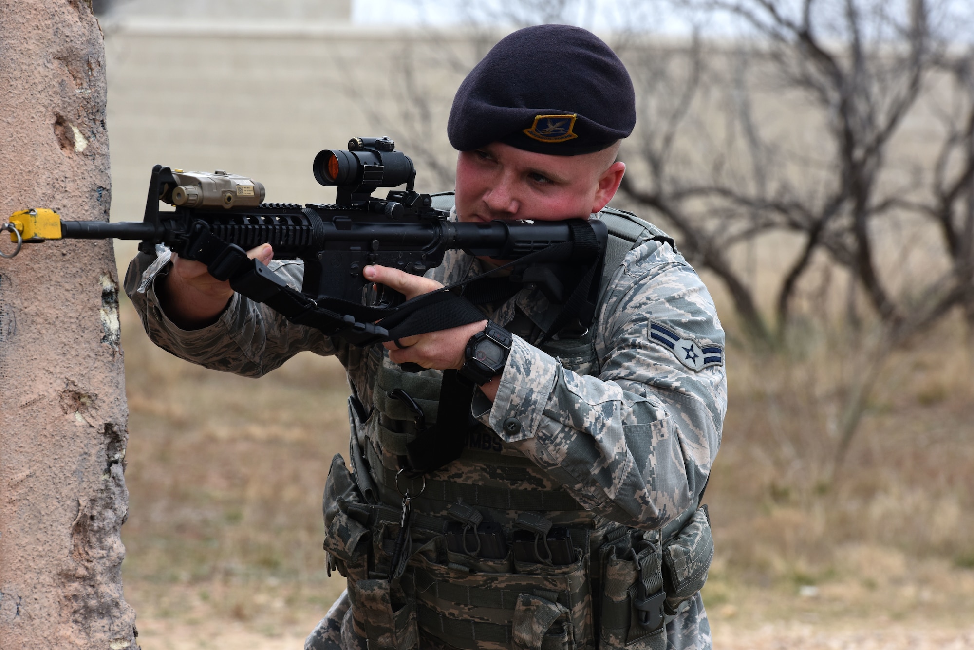 U.S. Air Force Airman 1st Class Dalton Combs, 17th Security Forces Squadron, takes cover and while watching for enemy forces during the final training exercise at the mock Forward Operating Base on Goodfellow Air Force Base, Texas, Feb. 28, 2018. The students in the Warrior Ancillary Specialized Training Program practiced covering techniques while moving forward on enemy forces and retreating. (U.S. Air Force photo by Airman 1st Class Seraiah Hines/Released)