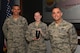 U.S. Air Force Airman 1st Class Cassidy Woody, 20th Fighter Wing (FW) Public Affairs broadcast journalist, center, is recognized as a Shaw “Weasel of the Week” by Col. Daniel Lasica, 20th FW commander, left, and Chief Master Sgt. Daniel Hoglund, 20th FW command chief, at Shaw Air Force Base, S.C., March 7, 2018.