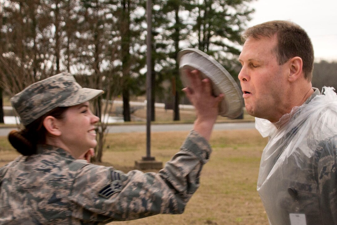 U.S. Air Force Reserve Senior Airman Carlie Creech, a dental technician assigned to the 913th Aerospace Medical Squadron, moves in to put a pie in face of Lt. Col. Kyle Wendfeldt, a 913 AMDS dentist, after the conclusion of the Unit Training Assembly (UTA) weekend at Little Rock Air Force Base, Ark., Mar. 4, 2018. The pie in the face event was used as a morale building fund raiser for the squadron. (U.S. Air Force photo by Master Sgt. Jeff Walston/Released)