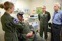 Dr. Stacy Zimmerman, an associate investigator, demonstrates using the Transcranial Magnetic Stimulation (TMS) on Capt. Josh Pearcy, a physician assistant, while Dr. Shane Biedermann and Dr. Harold Ginzburg observe. Biedermann, as the primary investigator, and his team, are looking for combat veteran volunteers with Post Traumatic Stress Disorder to participate in this noninvasive study using electroencephalography.
