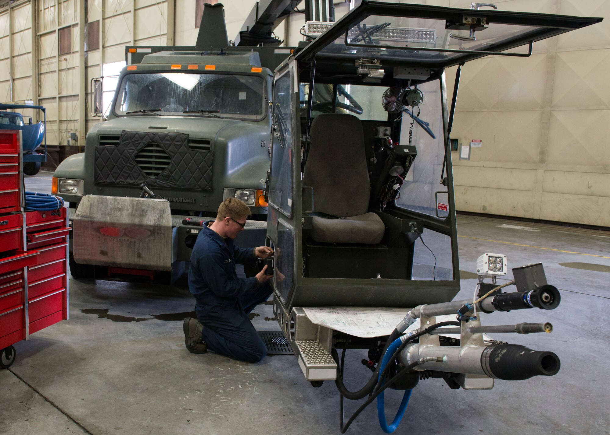 Airman 1st Class Craig Boudreau, a vehicle maintainer with the 673d Logistics Readiness Squadron, replaces a heater on a Global de-icer 1800 March 6, 2018, at Joint Base Elmendorf-Richardson, Alaska. Boudreau was handpicked to travel with an extended-reach deicer from Joint Base Elmendorf-Richardson, Alaska, to Gangneung Air Base, Republic of Korea, in support of Vice President of the United States Michael Pence’s visit to the Pyeongchang 2018 Winter Olympics.