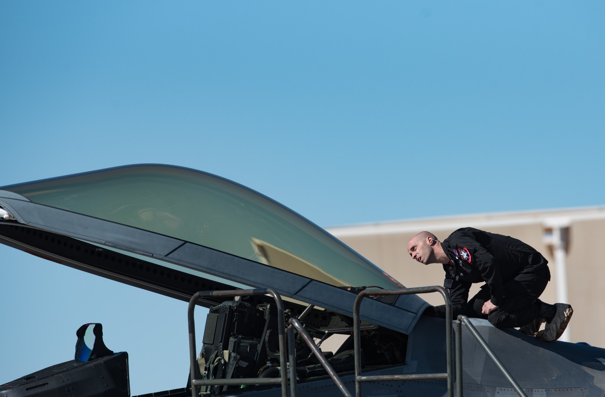 U.S. Air Force Staff Sgt. Nicholas Banducci, Air Combat Command F-22 Raptor Demonstration Team low observable aircraft structures technician, ensures an F-22 Raptor’s canopy maintains its low observablity during the U.S. Air Force Heritage Flight Training Course at Davis-Monthan Air Force Base, Arizona, March 1, 2017.