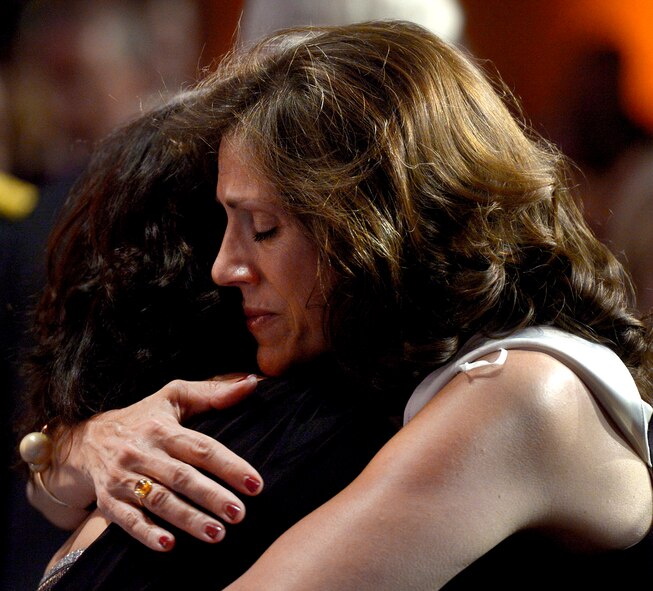 Attendees embrace after the 10th Annual Tragedy Assistance Program for Survivors Honor Guard Gala March 6, 2018, in Washington, D.C. The program has helped more than 70,000 surviving family members cope with the devastating loss of loved ones. (U.S. Air Force photo by Staff Sgt. Rusty Frank)