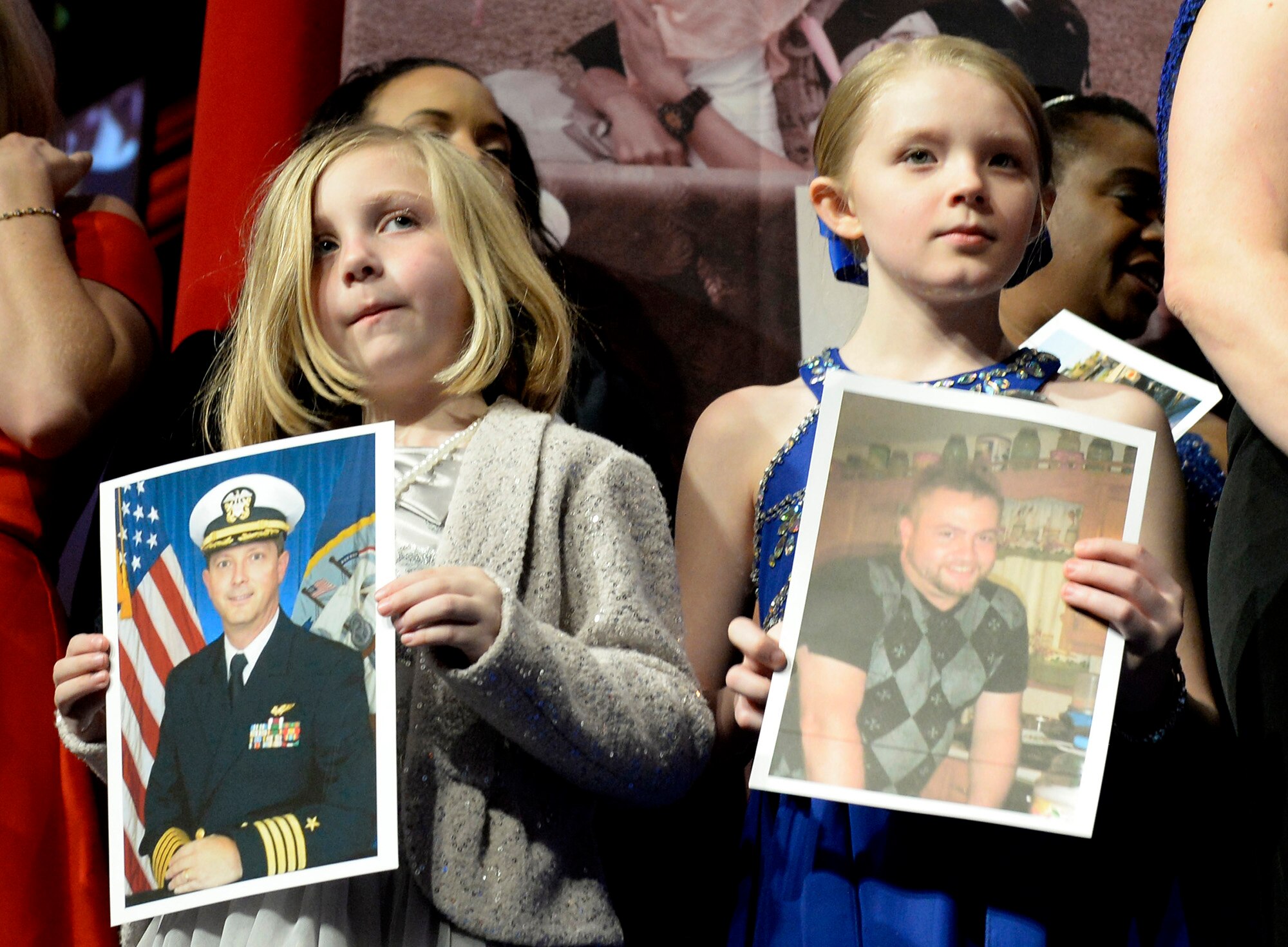 Family members hold photos of their fallen loved ones during the 10th Annual Tragedy Assistance Program for Survivors Honor Guard Gala March 6, 2018, in Washington, D.C. The program has helped more than 70,000 surviving family members cope with the devastating loss of loved ones. (U.S. Air Force photo by Staff Sgt. Rusty Frank)