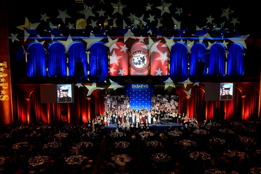 Family members hold photos of their fallen loved ones during the 10th Annual Tragedy Assistance Program for Survivors Honor Guard Gala March 6, 2018, in Washington, D.C. The program has helped more than 70,000 surviving family members cope with the devastating loss of loved ones. (U.S. Air Force photo by Staff Sgt. Rusty Frank)