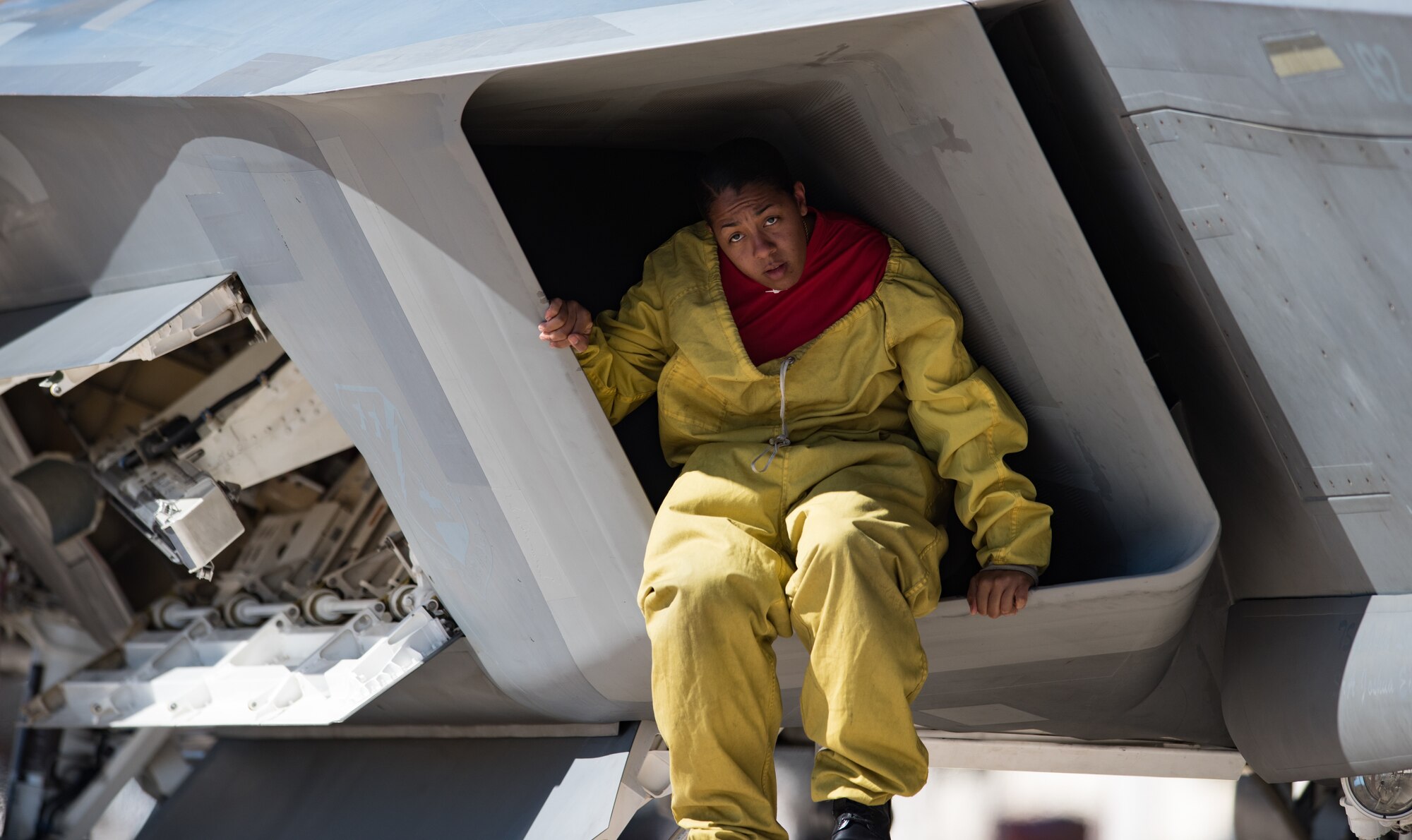 U.S. Air Force Tech. Sgt. Darshele Green, Air Combat Command Raptor Demostration Team avionics technician, climbs inside an F-22 Raptor’s engine intake post-flight at the U.S. Air Force Heritage Flight Training Course at Davis-Monthan Air Force Base, Arizona, March 1, 2017.