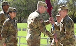 Maj. William K. White (center) took command of the U.S. Army Medical Command Center and School Headquarters Support Company, by accepting the unit colors from Col. Thomas S. Bundt (right), Chief of Staff AMEDDC&S. White comes to the HSC after serving as the executive of the Officer, Army-Baylor Graduate Program in Health and Business Administration. He replaces Maj. Lisa M. Chabot (left) who is retiring from the U.S. Army after 26 years of service. The change of command ceremony was held at the AMEDD Museum amphitheater.