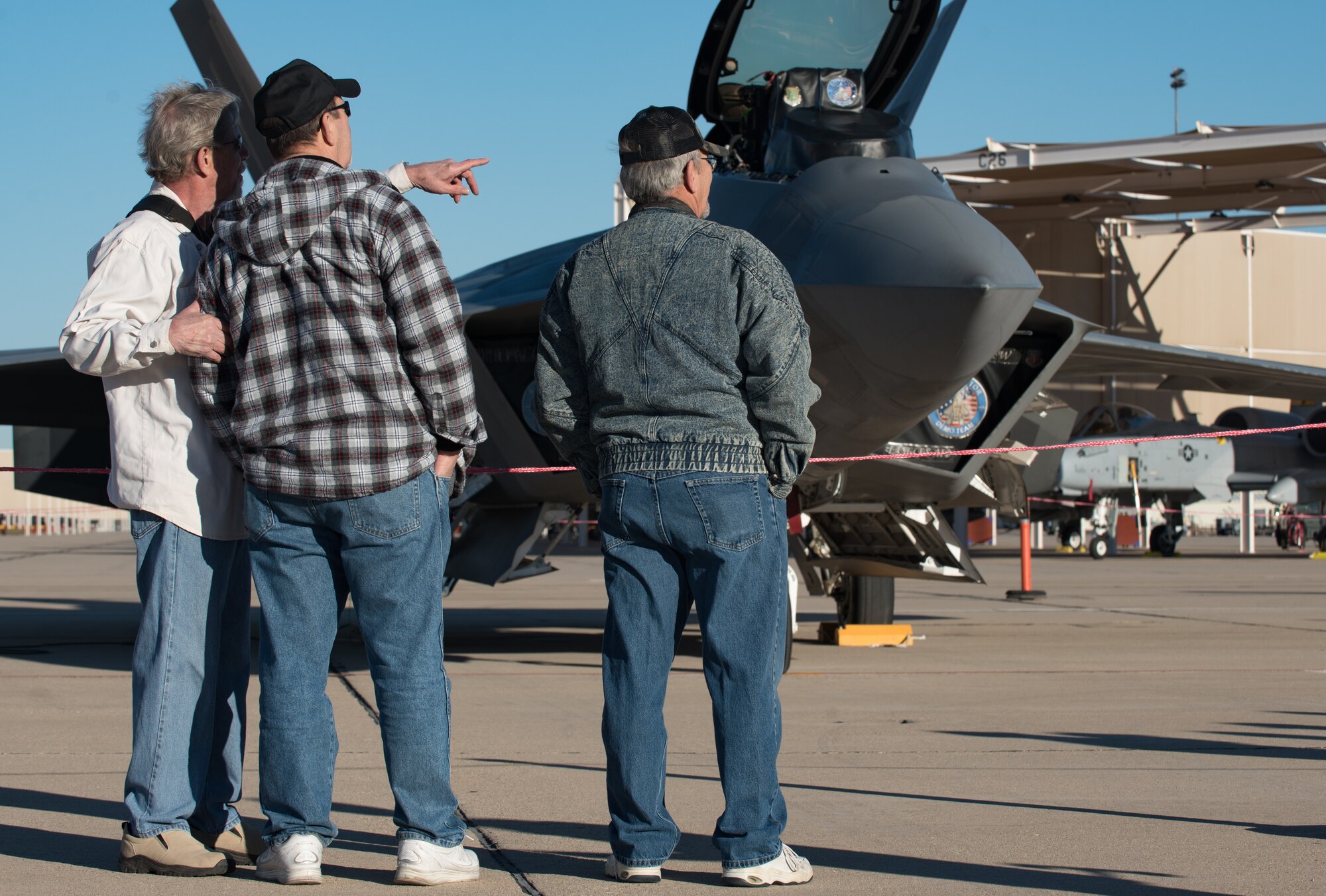 U.S. Air Force Heritage Flight Training Course spectators visit the Air Combat Command F-22 Raptor Demonstration Team before the Raptor team’s flight at Davis-Monthan Air Force Base, Arizona, March 2, 2017.