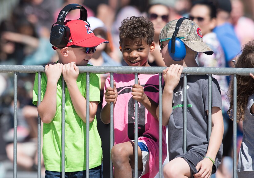 Children watch the Air Combat Command Raptor Demostration Team aerial demonstration during the U.S. Air Force Heritage Flight Training Course spectators at Davis-Monthan Air Force Base, Arizona, March 4, 2017.