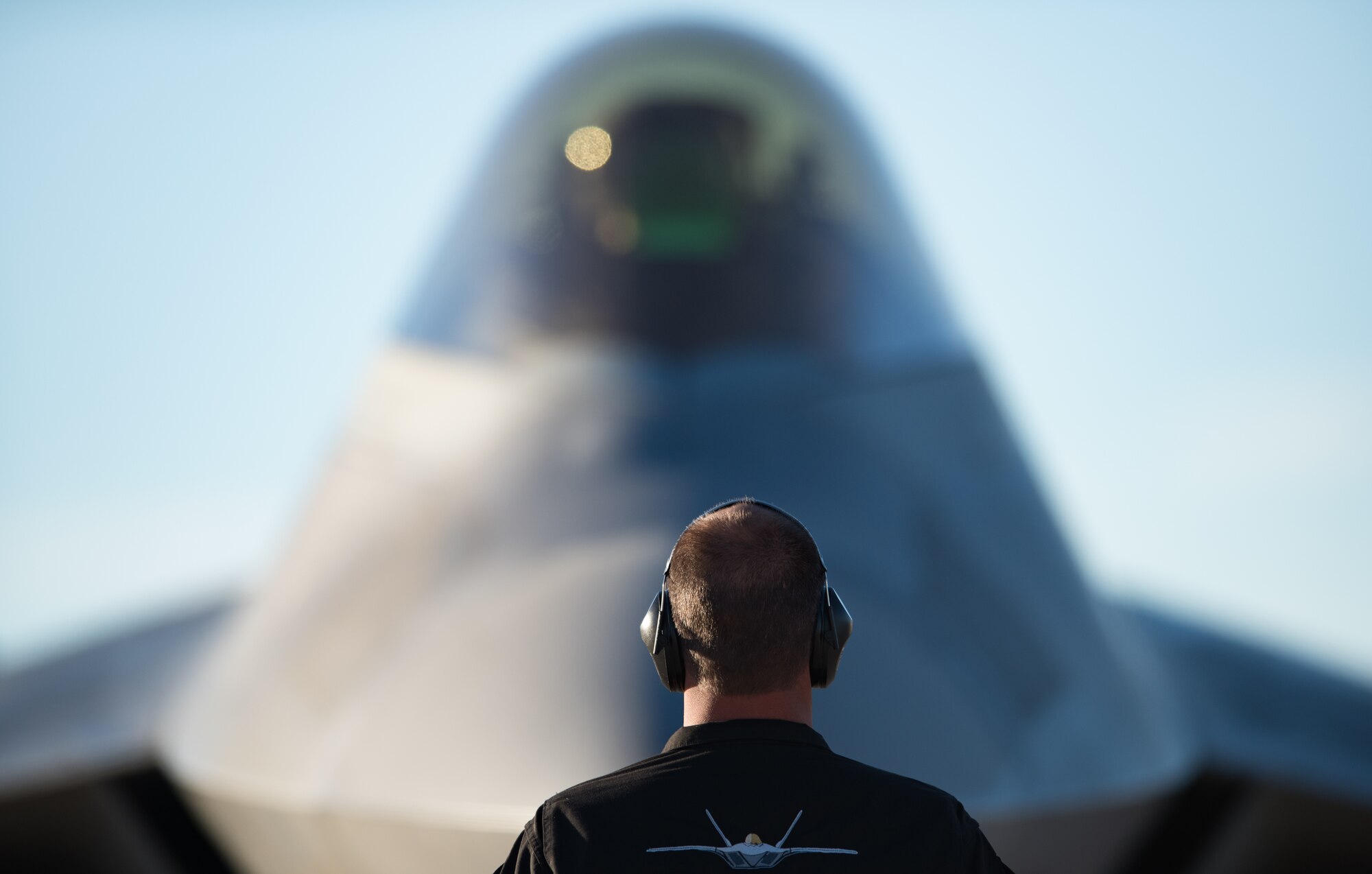 An Air Combat Command F-22 Raptor Demonstation Team crew chief directs parking an F-22 Raptor post-flight at the Heritage Flight Training Course at Davis-Monthan Air Force Base, Arizona, March 4, 2017.