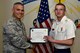 U.S. Air Force Col. Alex Ganster, 17th Training Group commander, presents the 17th TRG Student of the Month certificate to U.S. Army Private 2nd Class Tanner Doub, 312th Training Squadron trainee, in Brandenburg Hall on Goodfellow Air Force Base, Texas, March 2, 2018.  The 312th TRS’s mission is to provide Department of Defense and international customers with mission ready fire protection and special instruments graduates and provide mission support for the Air Force Technical Applications Center. (U.S. Air Force photo by Senior Airman Randall Moose/Released)