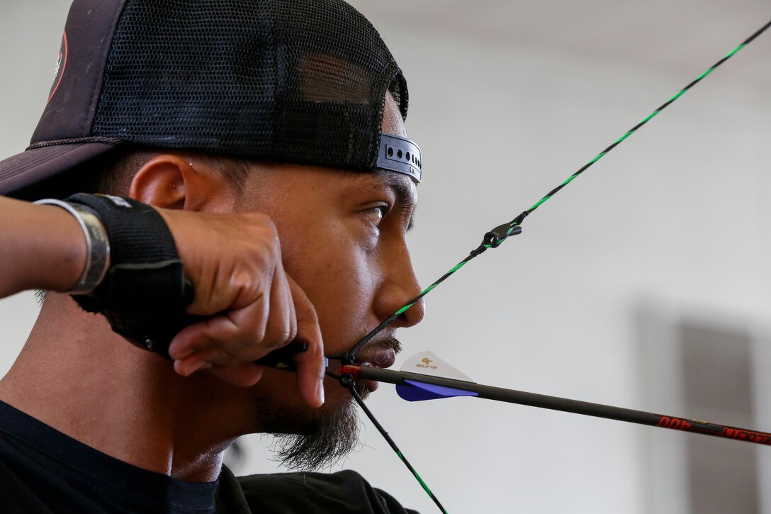 A soldier eyes a target during an archery competition.