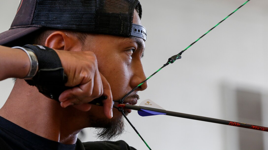 A soldier eyes a target during an archery competition.