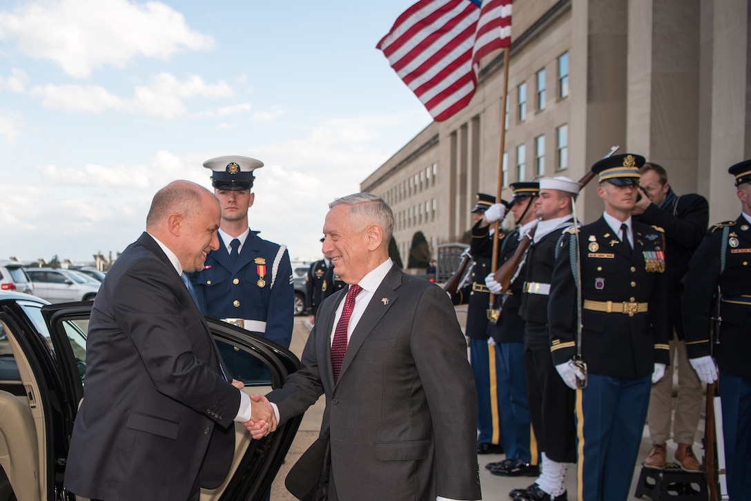 Secretary of defense greets Estonia's defense minister at the Pentagon.