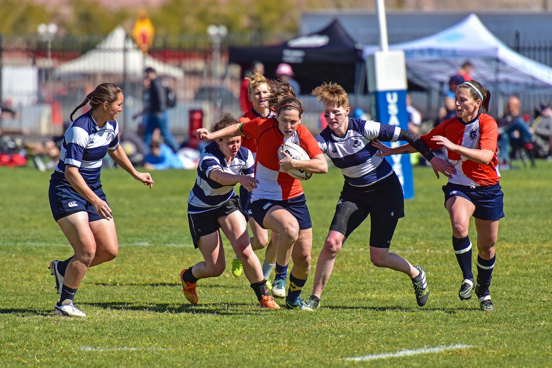 A Coast Guardsman from the service's women's rugby team, carries the ball during a match.