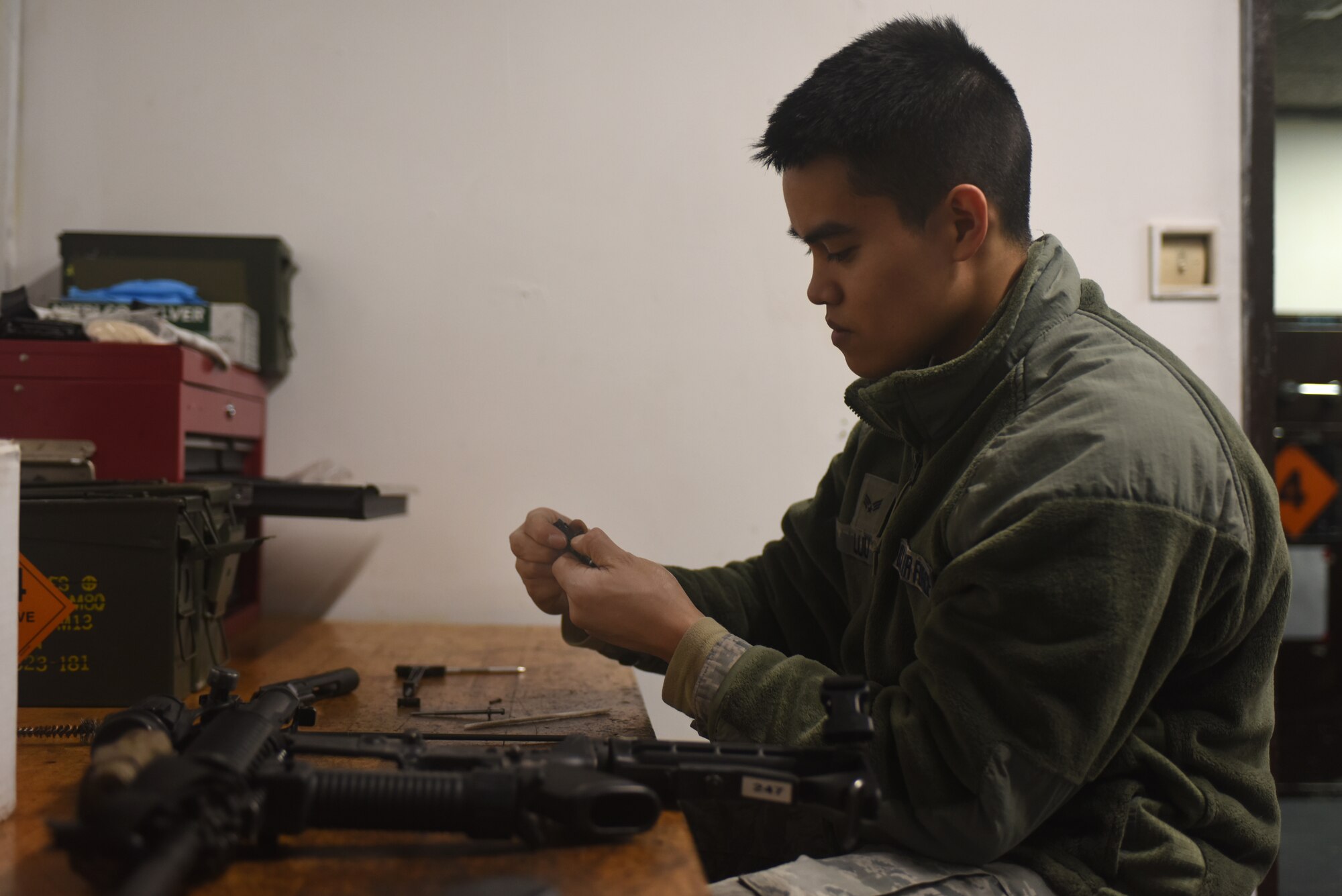 An Airman assigned to the 48th Security Forces Squadron’s armory cleans an M4 carbine at Royal Air Force Lakenheath, England, Feb. 20. Airmen assigned to the armory are responsible for arming and de-arming security forces Airmen during each shift change, as well as ensuring issued weapons are being cleaned properly. (U.S. Air Force photo/Airman 1st Class Eli Chevalier)