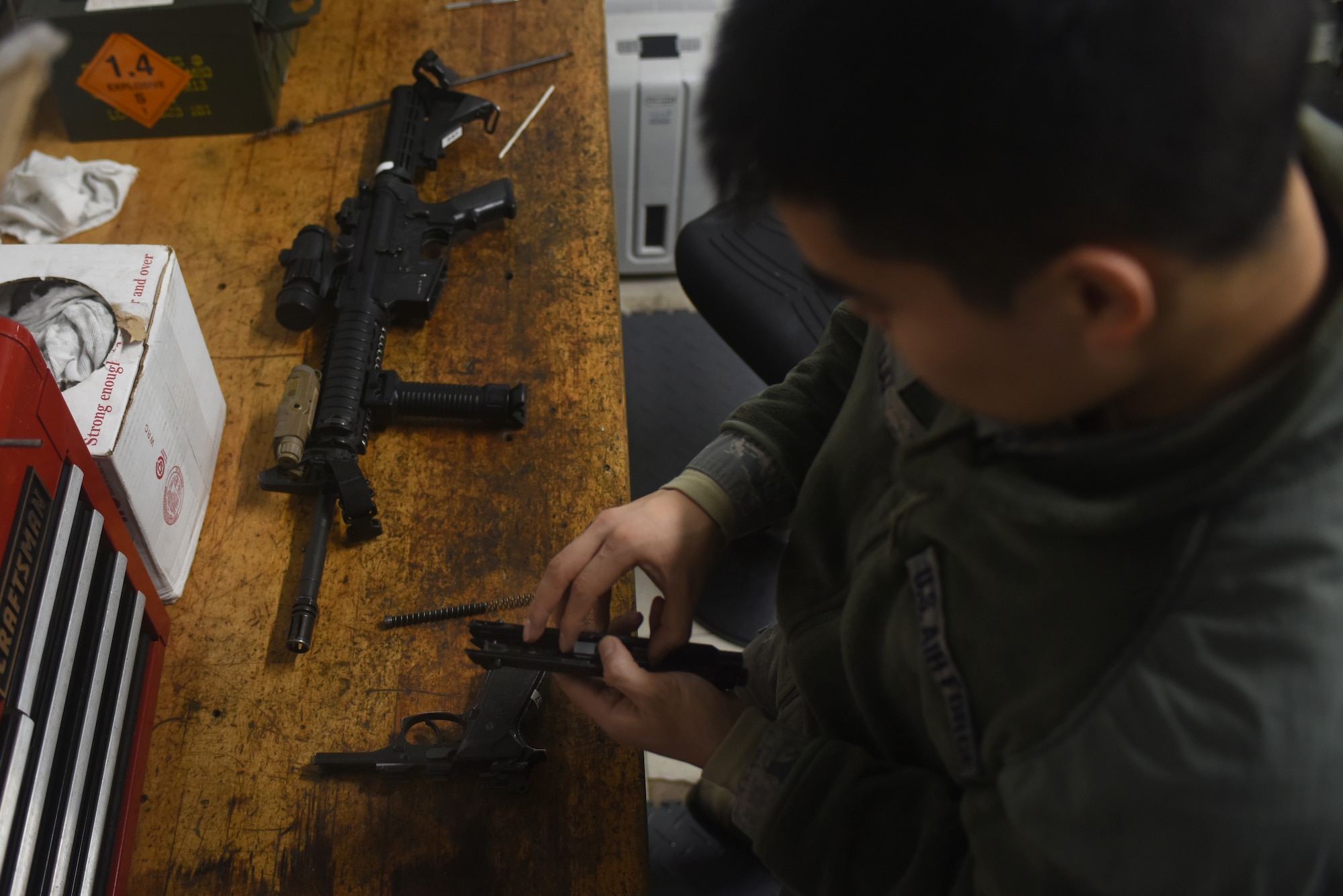 An Airman assigned to the 48th Security Forces Squadron’s armory assembles an M9 pistol at Royal Air Force Lakenheath, England, Feb. 20. Armory Airmen are responsible for all of the 48th SFS weapons. (U.S. Air Force photo/Airman 1st Class Eli Chevalier)