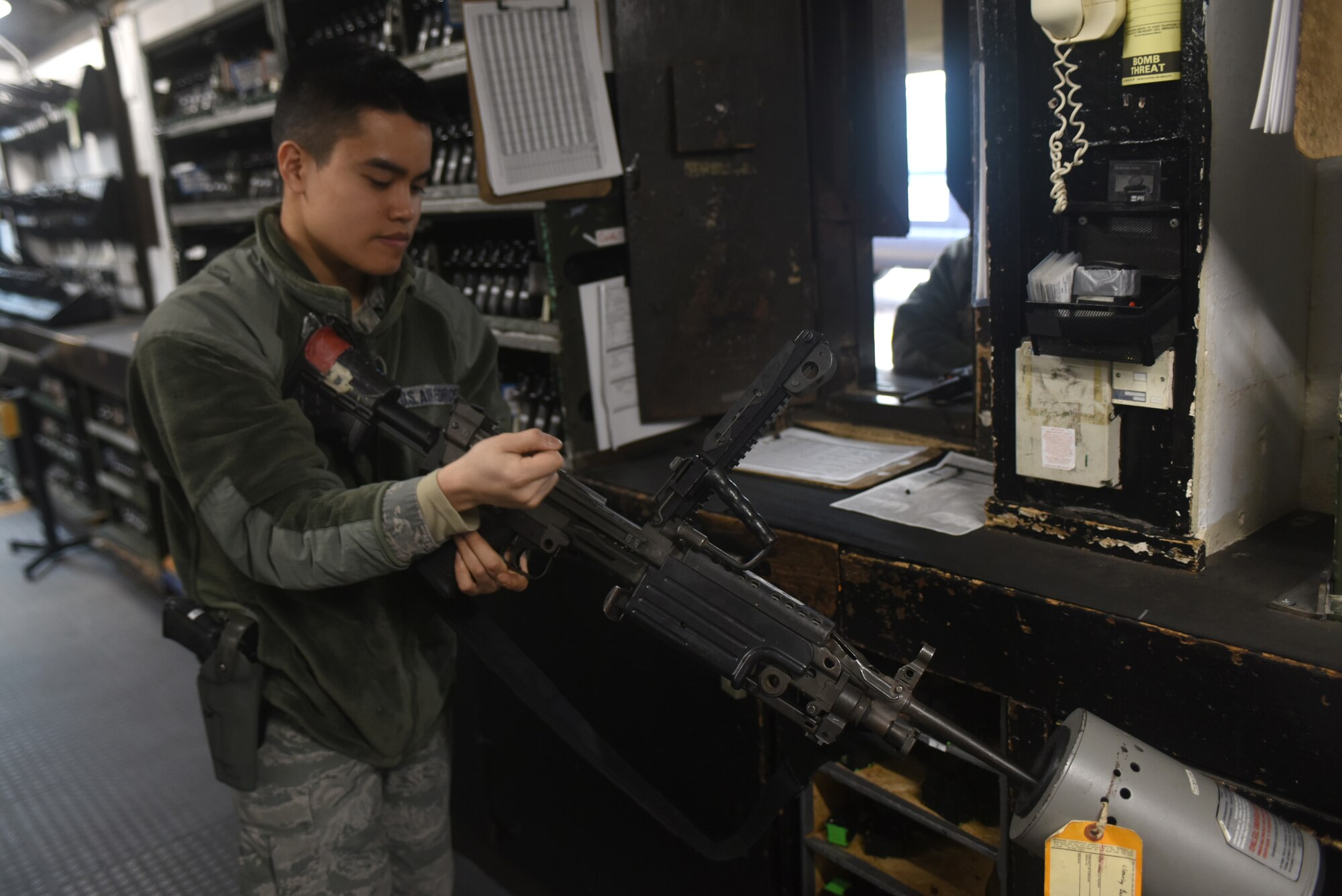An Airman assigned to the 48th Security Forces Squadron’s armory clears an M249 light machine gun at Royal Air Force Lakenheath, England, Feb. 20. Airmen assigned to the armory are responsible for arming and de-arming security forces Airmen during each shift change, as well as ensuring issued weapons are being cleaned properly. (U.S. Air Force photo/Airman 1st Class Eli Chevalier)