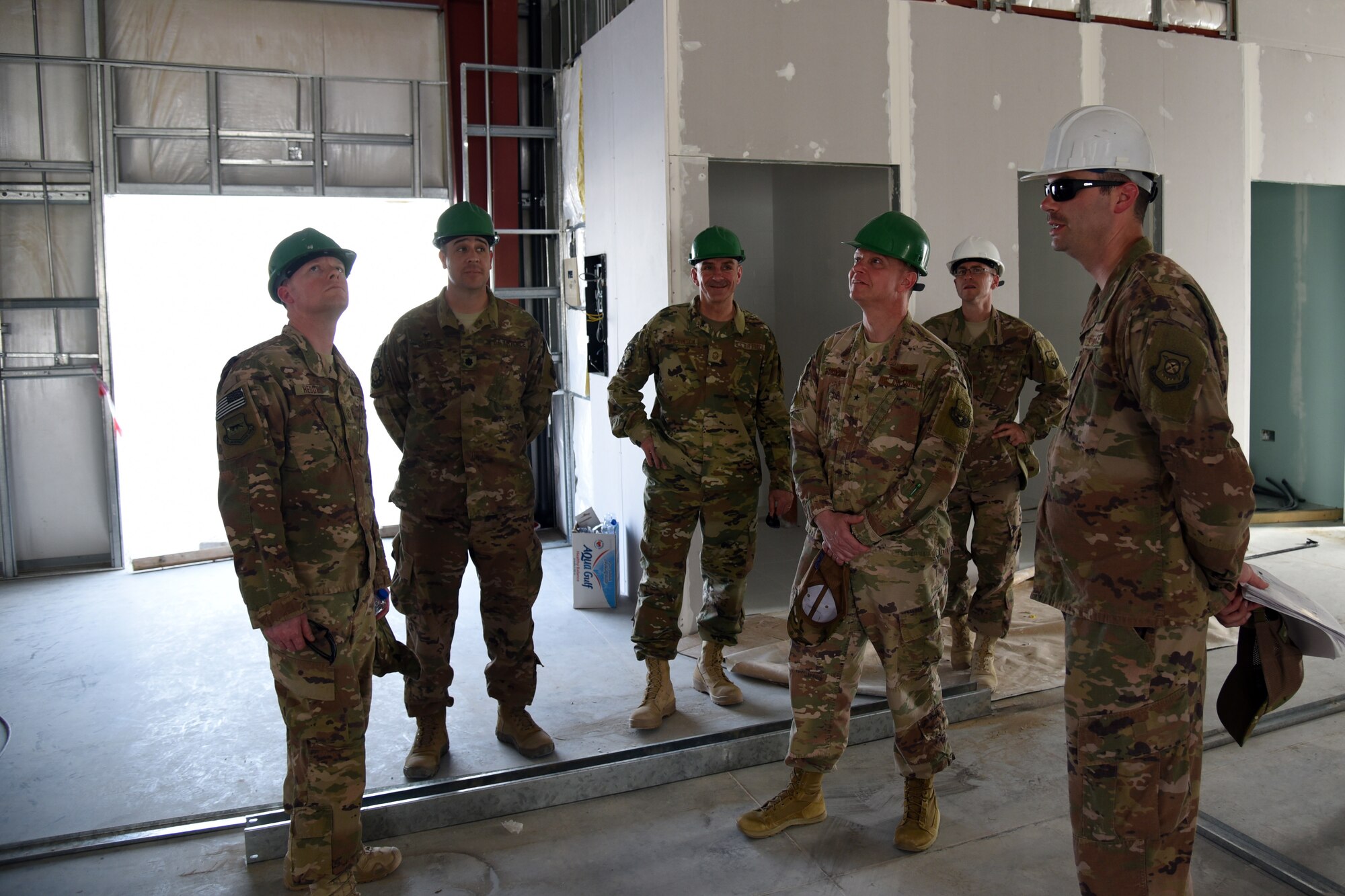 U.S. Air Force Brig. Gen. Kyle Robinson, 332nd Air Expeditionary Wing commander, and Chief Master Sgt. Benjamin Hedden, 332nd command chief, tour a construction site at an undisclosed location in Southwest Asia March 5. During the visit, Robinson and Hedden toured several projects that the 407th Expeditionary Civil Engineer Squadron and contractors are working on. (U.S. Air Force photo by Staff Sgt. Joshua Edwards/Released)