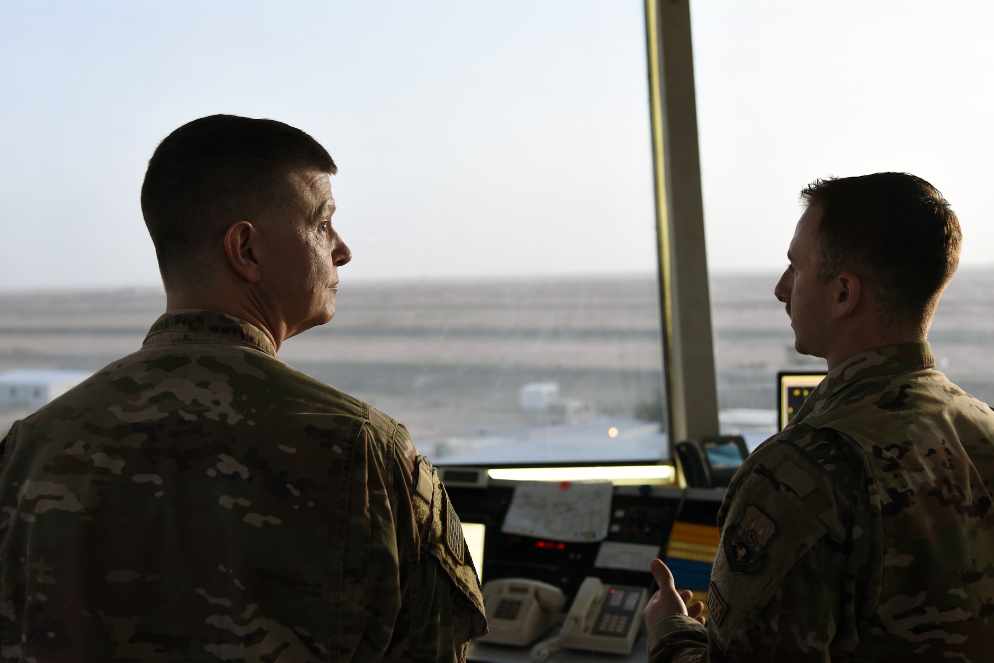 U.S. Air Force Brig. Gen. Kyle Robinson, 332nd Air Expeditionary Wing commander, tours the air traffic controller with 1st Lt. Ryan Royer, 407th Expeditionary Operation Support Squadron Airfield Operations Flight commander, at an undisclosed location in Southwest Asia March 5. Royer and other commanders showed Robinson different sections of the base to give him an overview of the 407th Air Expeditionary Group. (U.S. Air Force photo by Staff Sgt. Joshua Edwards/Released)