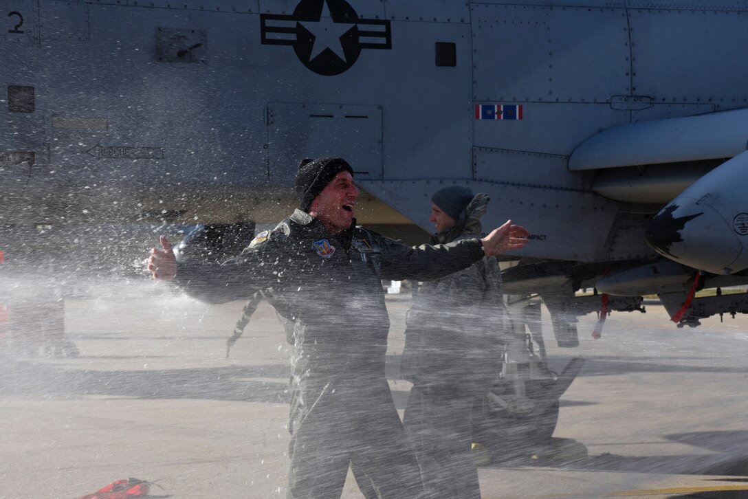Air Force Col. Paul Zurkowski, a pilot assigned to the 104th Fighter Squadron, is sprayed by family members March 3rd, 2018, after his fini flight at Warfield Air National Guard Base, Middle River, Md.