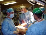 Col. Shawn C. Nessen (center), commander of the 541st (Airborne) Forward Surgical Team in Afghanistan, works on a patient in the operating room while deployed in support of Operation Enduring Freedom.