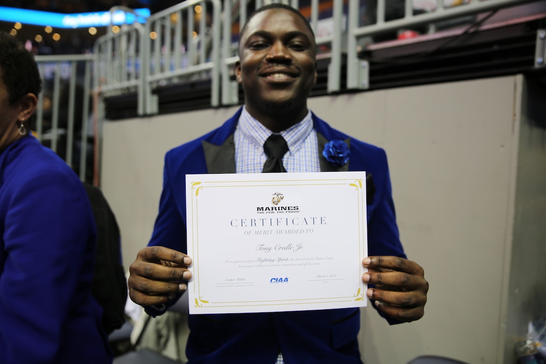 Tony Credle Jr. poses with his certificate of merit during the men’s semifinals of the Central Intercollegiate Athletic Association (CIAA) Basketball Tournament at the Spectrum Center in Charlotte, March 2. During the tournament, the CIAA also took time to recognize the contributions and successes of 100 years of women in the Marine Corps with a presentation during the men's semifinals. The CIAA Basketball Tournament is scheduled for Feb. 27 to March 3, 2018 in Charlotte. Credle is a senior at Fayetteville State University.