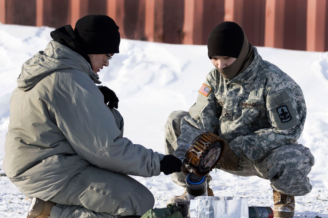 Soldiers prepare heating equipment.