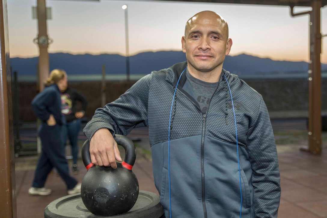 U.S. Marine Corps Chief Warrant Officer 3 Enrique Laguna, the Marine Corps Air Station (MCAS) Iwakuni telephone systems officer with Headquarters and Headquarters Squadron, poses for a photo after a High Intensity Tactical Training session at MCAS Iwakuni, Japan, March 6, 2018 Laguna instructs HITT classes three times a day to help Marines, and anyone else on the air station, achieve and surpass their fitness goals.
